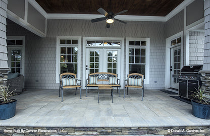 Rear porch with covered deck and outdoor kitchen pictured for Markham house plan 1299