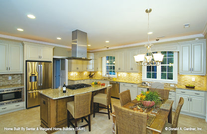 Kitchen pictured with island and roomy countertop work space of Marley house plan 1285