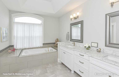 Double sink vanity next to the soaking tub in the master bathroom. The Mayfair plan 1317.