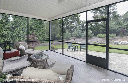 View out to the back lawn from the screened in porch. The Mayfair plan 1317.