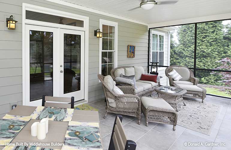 Conversation seating and dining seating in the screened in porch. The Mayfair plan 1317.