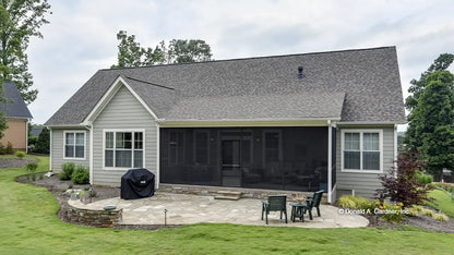 Rear view photograph with screened in porch. The Mayfair plan 1317.