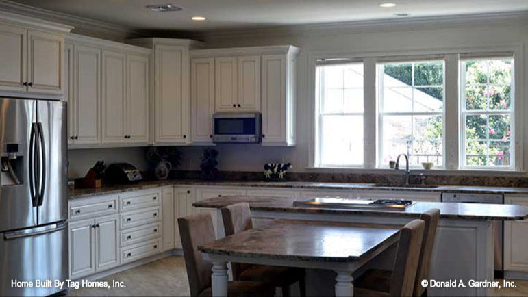 Triple windows behind the kitchen sink. The Merrill plan 1209