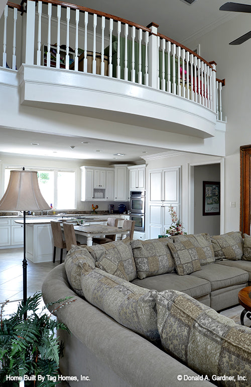 Great room view into the kitchen with banister above. The Merrill plan 1209