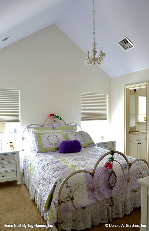 Cathedral ceiling with chandelier in the secondary bedroom. The Merrill plan 1209