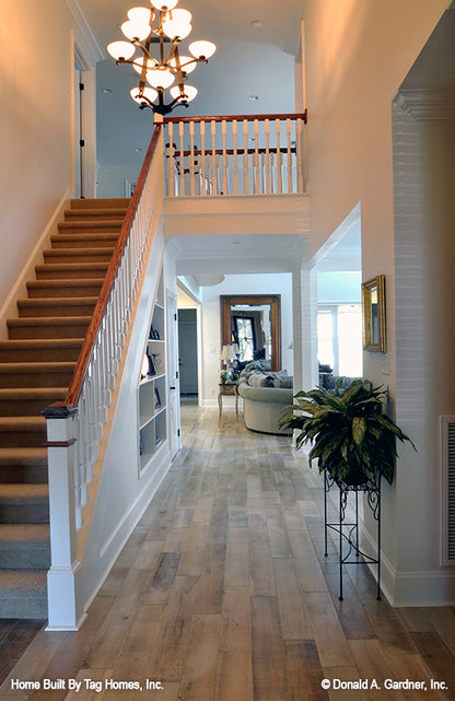 Staircase and chandelier in the foyer. The Merrill plan 1209