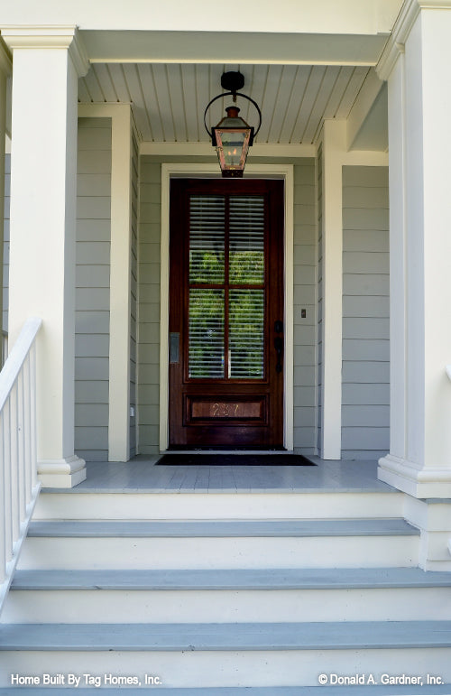 Light blue and white steps leading to the front porch. The Merrill plan 1209