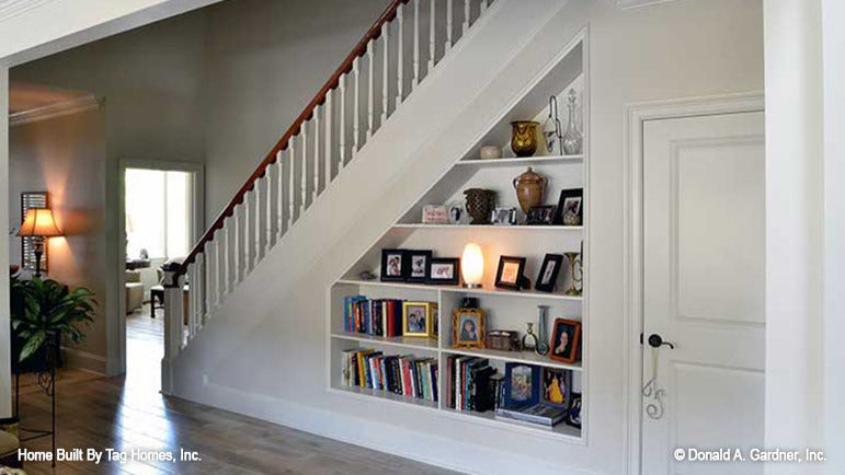 Built in bookshelves under the staircase. The Merrill plan 1209