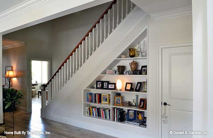 Built in bookshelves under the staircase. The Merrill plan 1209