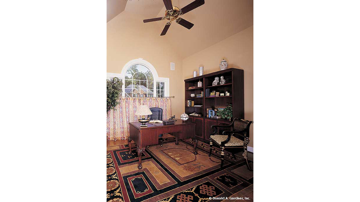 Vaulted ceiling with ceiling fan in the study. The Milford plan 331. 