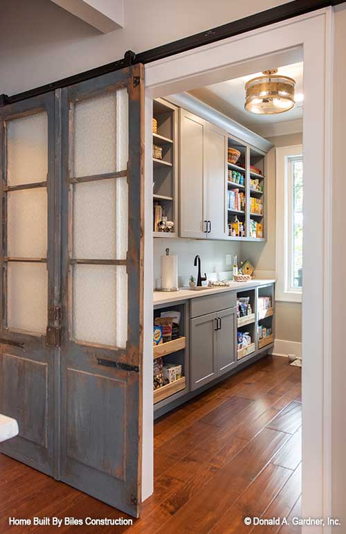 Farmhouse door leading to this large walk-in pantry.  The Mitchell 1413