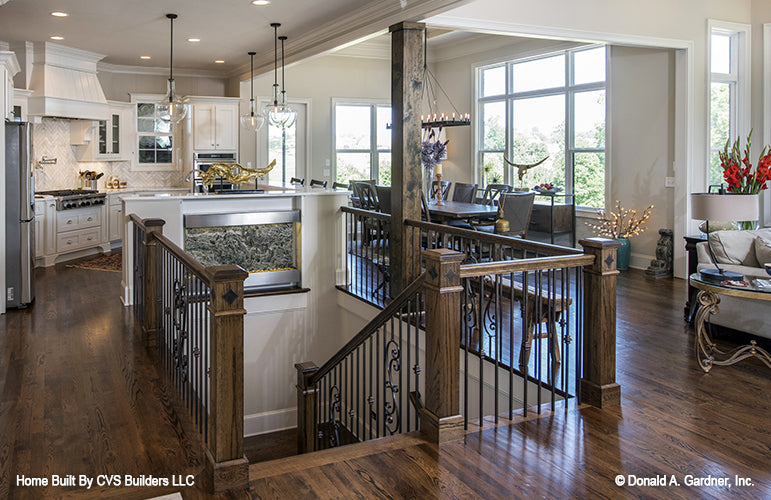 Wood flooring and white cabinets in the kitchen. The Monarch Manor plan 5040.