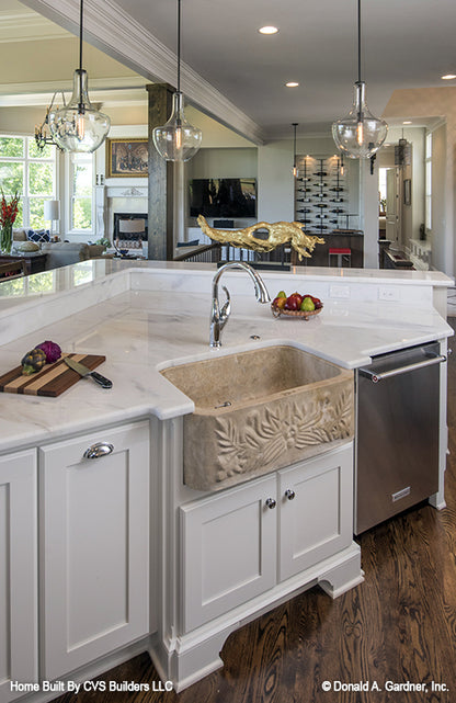 Hanging pendant lighting over the island in the kitchen. The Monarch Manor plan 5040.