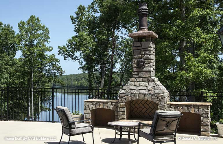 Outdoor stone fireplace. The Monarch Manor plan 5040.