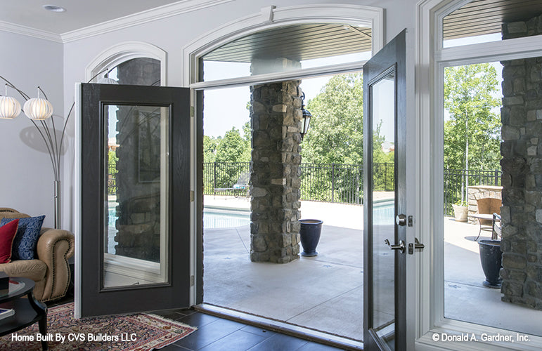 Open French glass doors to the rear patio. The Monarch Manor plan 5040.