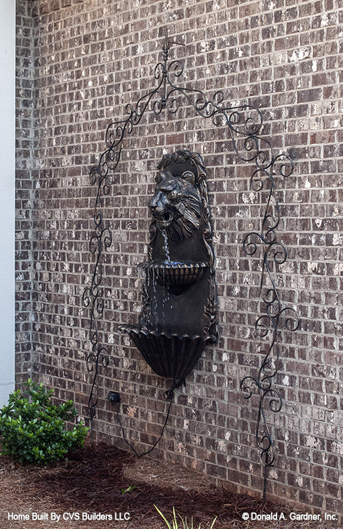 Lion water fountain on the exterior wall. The Monarch Manor plan 5040.