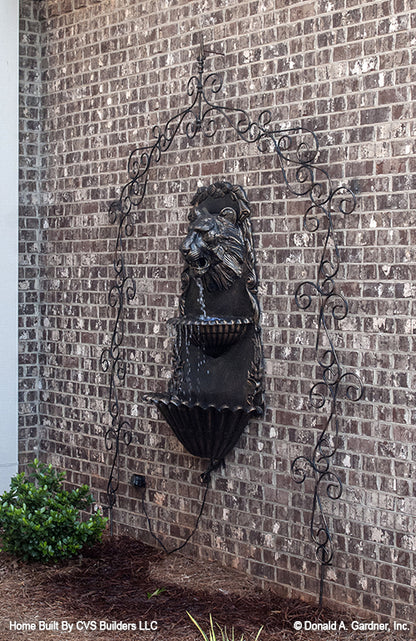 Lion water fountain on the exterior wall. The Monarch Manor plan 5040.