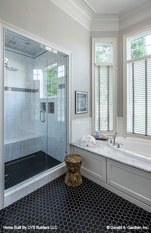 See through glass door to the walk-in shower in the master bathroom. The Monarch Manor plan 5040.