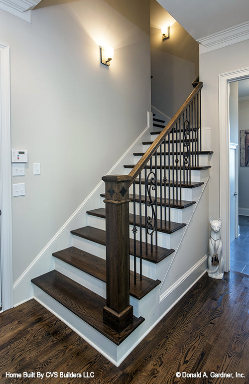 Sconce lighting going up the staircase. The Monarch Manor plan 5040.