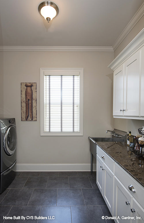 White cabinets in the utility room. The Monarch Manor plan 5040.