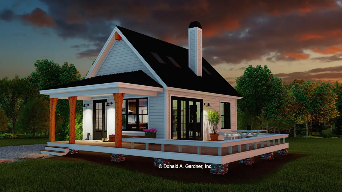 This is an illustration of the front of cabin house plan 1560 The Montana at dusk