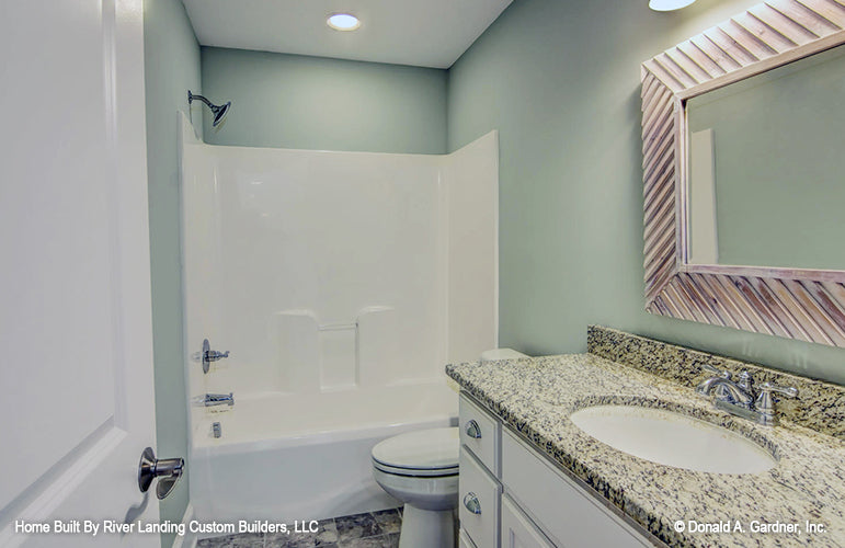 Single sink vanity and shower bathtub combo in the bathroom. The Newcastle plan 994.