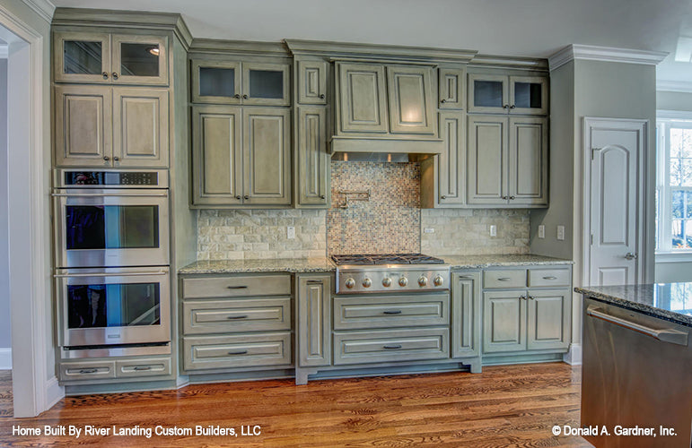 Sage green cabinets in the kitchen. The Newcastle plan 994.