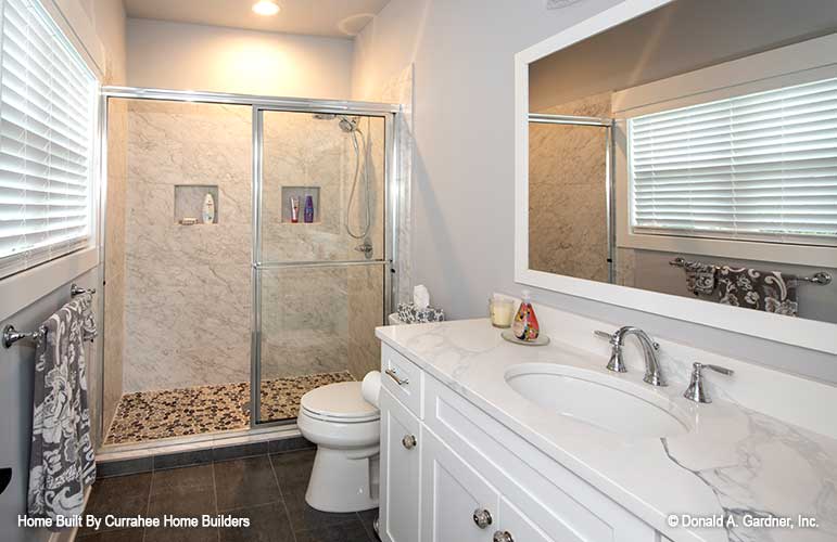 Single sink vanity and walk-in shower in the bathroom. The Nicholette plan 1520.