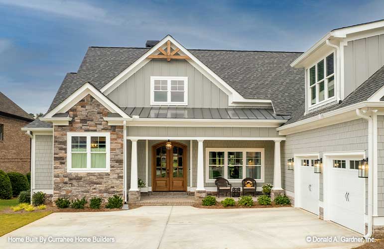 Front porch view with the 2 car garage off to the right. The Nicholette plan 1520.