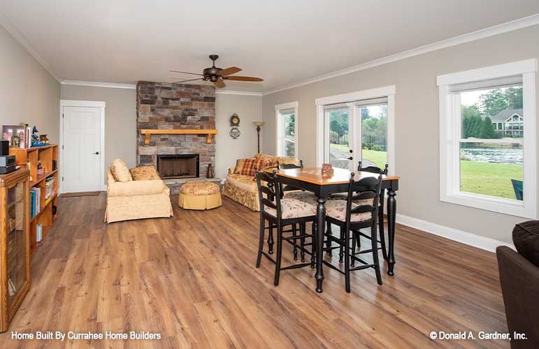 Stone fireplace and wood floors in the rec room. The Nicholette plan 1520.