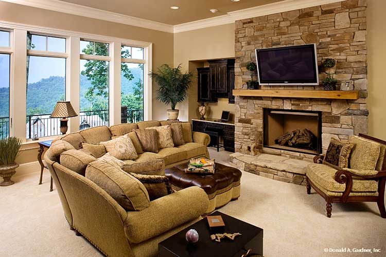 Floor to ceiling stone fireplace in the entertainment room. The Oak Abbey plan 5003.