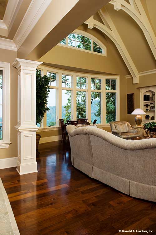 White wood beams on the ceiling in the great room. The Oak Abbey plan 5003.