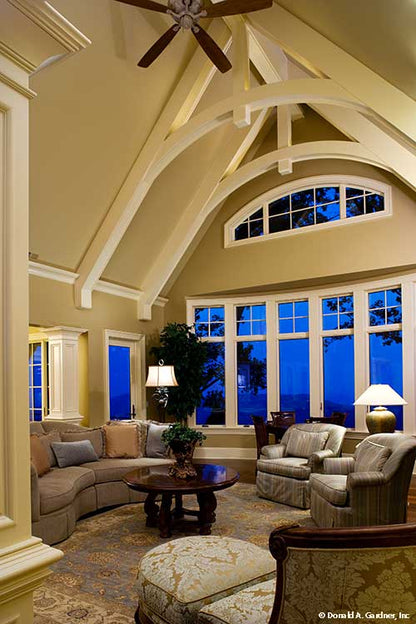 Vaulted ceiling and arched window in the great room. The Oak Abbey plan 5003.