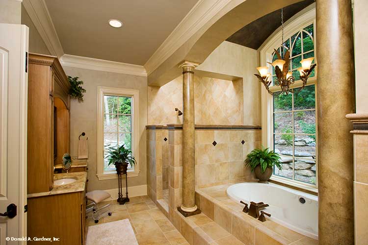 Soaking tub with large window in the master bedroom. The Oak Abbey plan 5003.