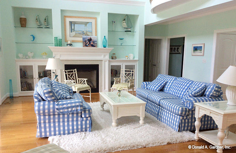 Built in cabinets and shelves beside the fireplace in the great room. The Oakmont plan 318.