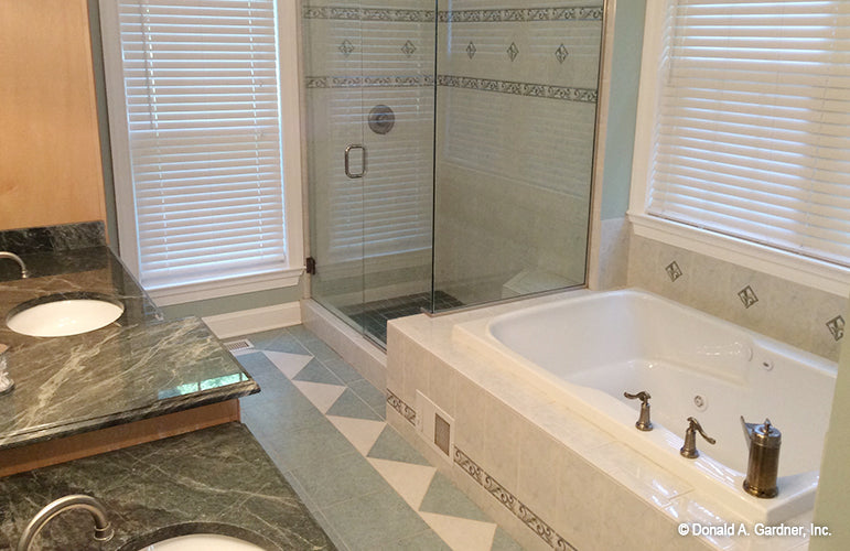 Soaking tub next to the walk-in shower in the master bathroom. The Oakmont plan 318.