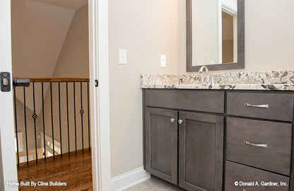 Second story bath picture shows railing overlooking great room for plan 1428 The Oscar