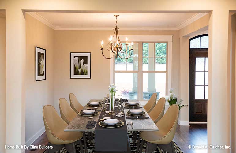 Elegant dining space on front of the home pictured for plan 1428 The Oscar