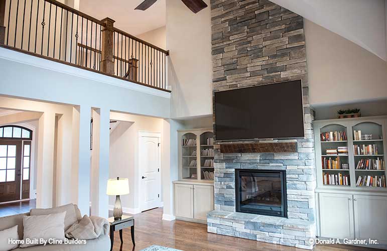 Two story ceiling in the great room pictured with fireplace and balcony to second floor for plan 1428 The Oscar