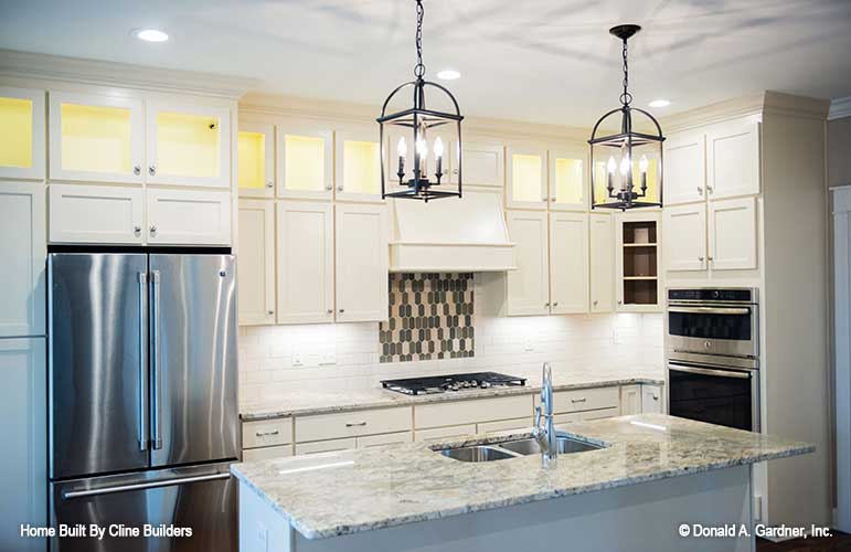 Eye catching kitchen elements and island with sink pictured for plan 1428 The Oscar