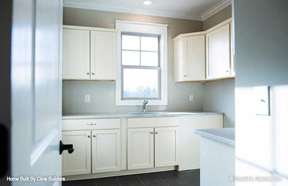 Open utility room with natural light and sink shown for plan 1428 The Oscar