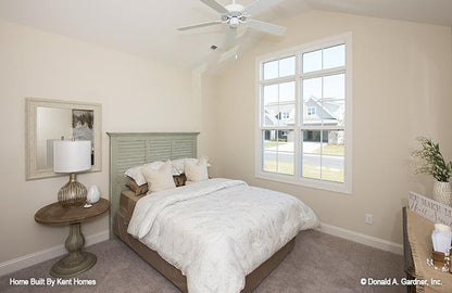 Cathedral ceiling and ceiling fan in the secondary bedroom. The Padgett plan 1124.