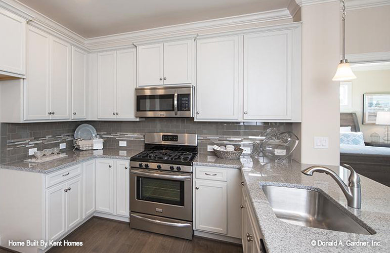 White cabinets in the kitchen. The Padgett plan 1124.