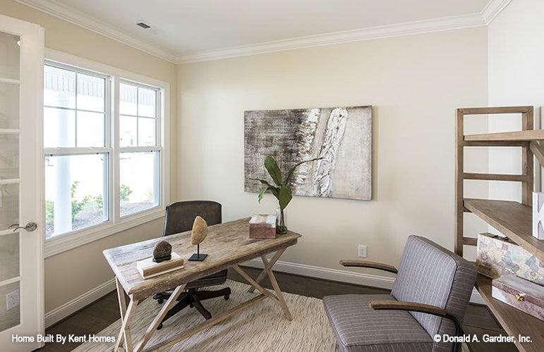 Double windows and crown molding along the ceiling in the study. The Padgett plan 1124.