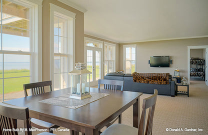 Well-lit family room with windows and glass patio doors. The Palm Lily plan 845. 