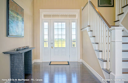 Entry door trimmed with windows in the foyer. The Palm Lily plan 845. 