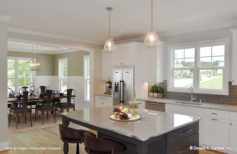 Open floor showing the kitchen island and the dining room off to the side. Paxton plan 1510