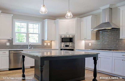 Beautiful kitchen with island and white cabinets. Paxton plan 1510