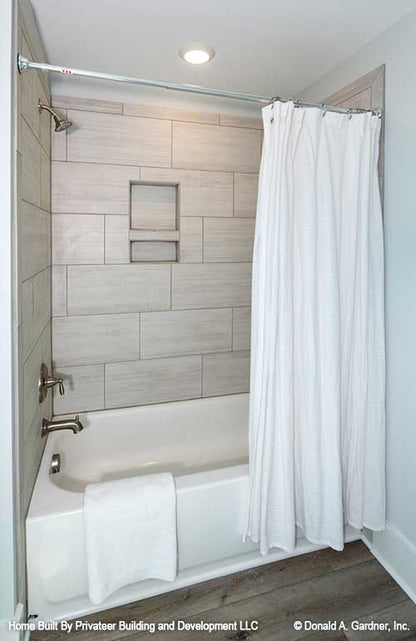 Ceramic tiling in bathtub and shower head in bathroom. Percy plan 1503