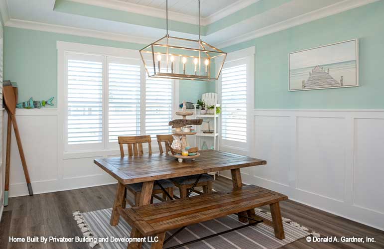 Dining room with tray ceiling and windows encased with molding. Percy plan 1503